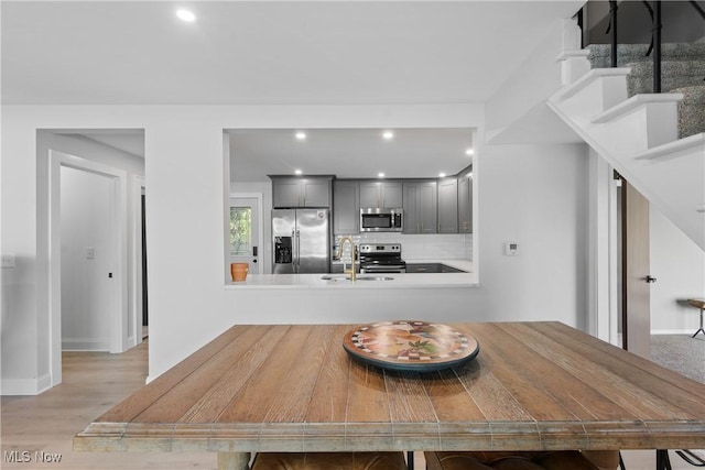 3350 S Main St, Akron, OH 44319 - dining space featuring light wood-style flooring, recessed lighting, and stairway