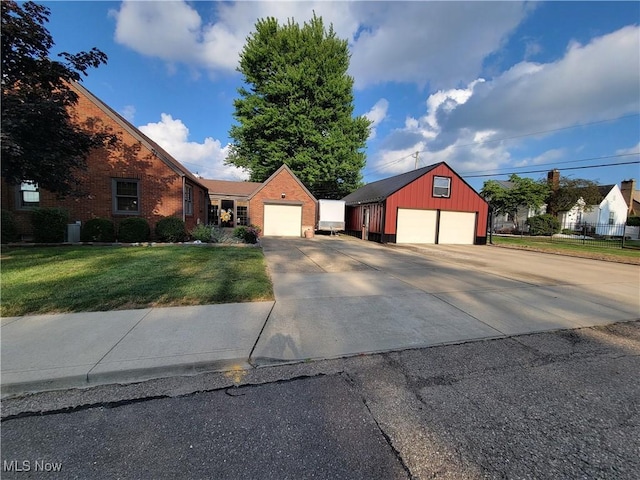 4626 7th St SW, Canton, OH 44708 - view of front facade featuring a front yard, a detached garage, brick siding, an outdoor structure, and board and batten siding
