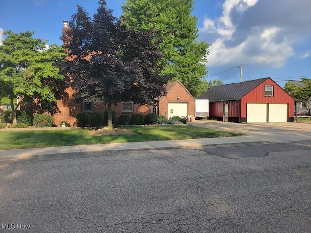 4626 7th St SW, Canton, OH 44708 - view of front facade with a garage, a front lawn, an outdoor structure, and brick siding