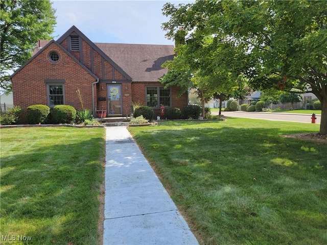 4626 7th St SW, Canton, OH 44708 - tudor-style house with brick siding and a front lawn