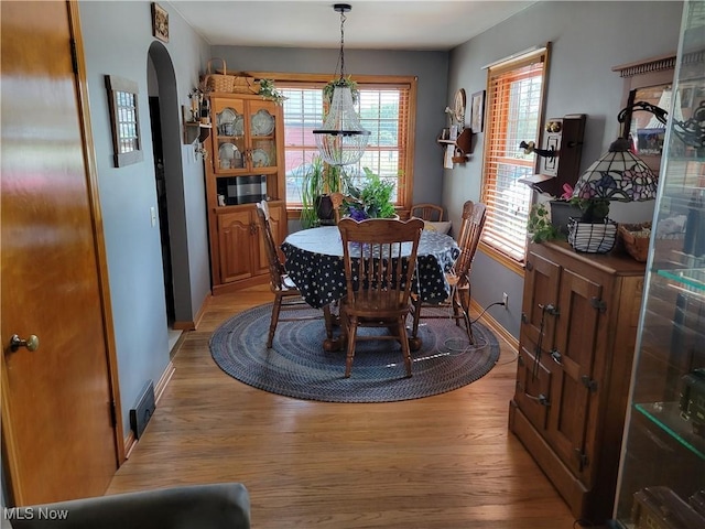 4626 7th St SW, Canton, OH 44708 - dining area featuring light wood-style flooring and arched walkways