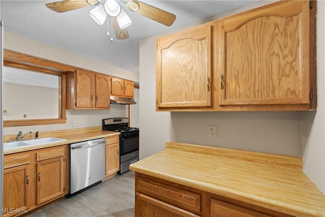 3139 Prior Dr, Cuyahoga Falls, OH 44223 - kitchen featuring appliances with stainless steel finishes, light wood-style floors, light countertops, a ceiling fan, and under cabinet range hood