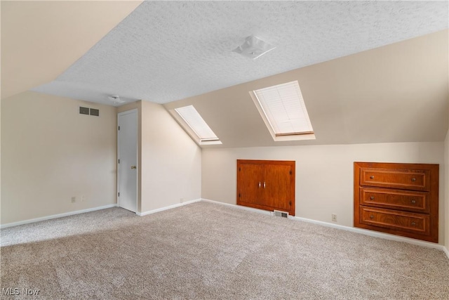 3139 Prior Dr, Cuyahoga Falls, OH 44223 - additional living space featuring a skylight, carpet floors, a textured ceiling, and lofted ceiling