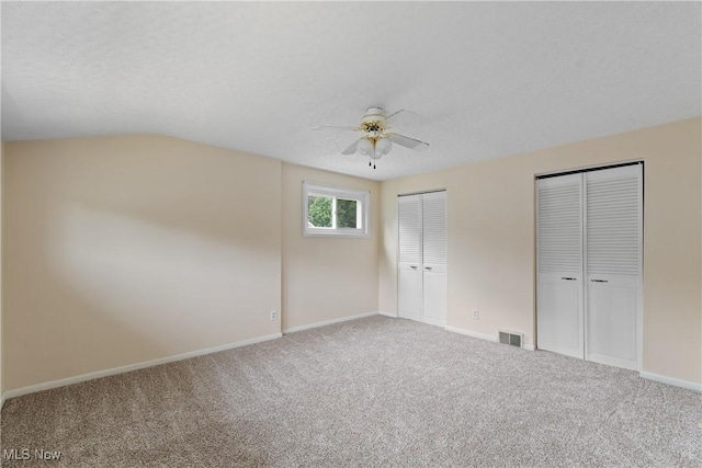 3139 Prior Dr, Cuyahoga Falls, OH 44223 - unfurnished bedroom with two closets, carpet, ceiling fan, and vaulted ceiling