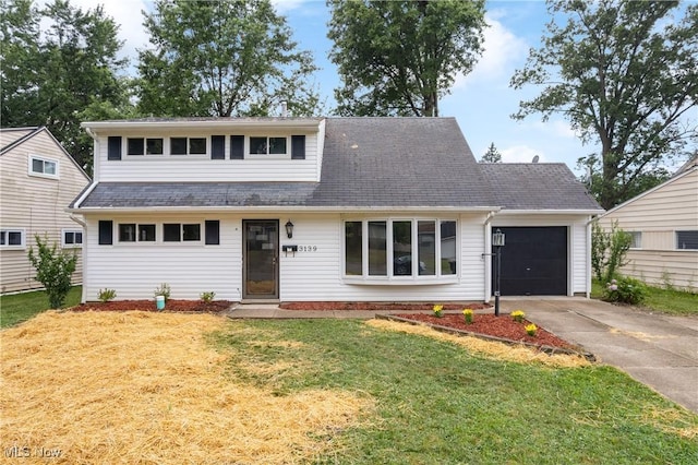 3139 Prior Dr, Cuyahoga Falls, OH 44223 - view of front of property with a garage, concrete driveway, a front yard, and a shingled roof