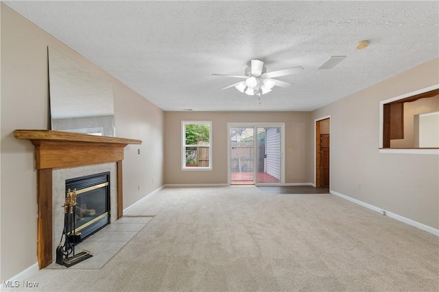 3139 Prior Dr, Cuyahoga Falls, OH 44223 - unfurnished living room with carpet flooring, ceiling fan, a tiled fireplace, and a textured ceiling