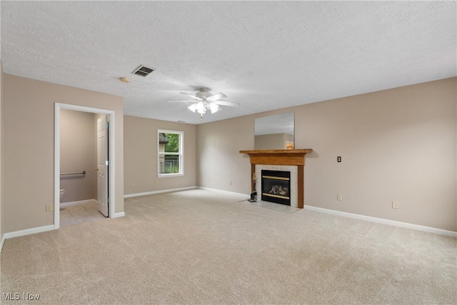 3139 Prior Dr, Cuyahoga Falls, OH 44223 - unfurnished living room featuring a textured ceiling, light carpet, a fireplace, and a ceiling fan