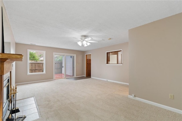 3139 Prior Dr, Cuyahoga Falls, OH 44223 - unfurnished living room with ceiling fan, carpet, a textured ceiling, and a glass covered fireplace