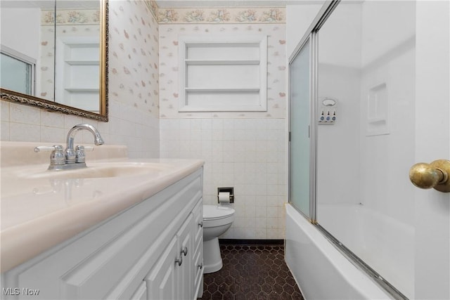 3139 Prior Dr, Cuyahoga Falls, OH 44223 - full bathroom featuring tile walls, vanity, combined bath / shower with glass door, wainscoting, and wallpapered walls
