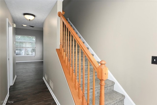 8714 Quailridge Ct, Macedonia, OH 44056 - stairs featuring wood finished floors and a textured ceiling