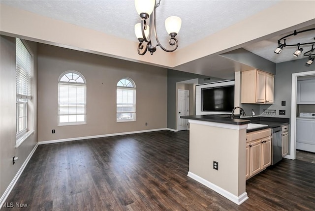 8714 Quailridge Ct, Macedonia, OH 44056 - kitchen featuring dark countertops, washer / clothes dryer, a chandelier, dark wood-style flooring, and a textured ceiling