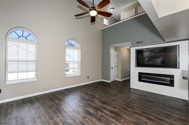 8714 Quailridge Ct, Macedonia, OH 44056 - unfurnished living room with ceiling fan, wood finished floors, and a high ceiling