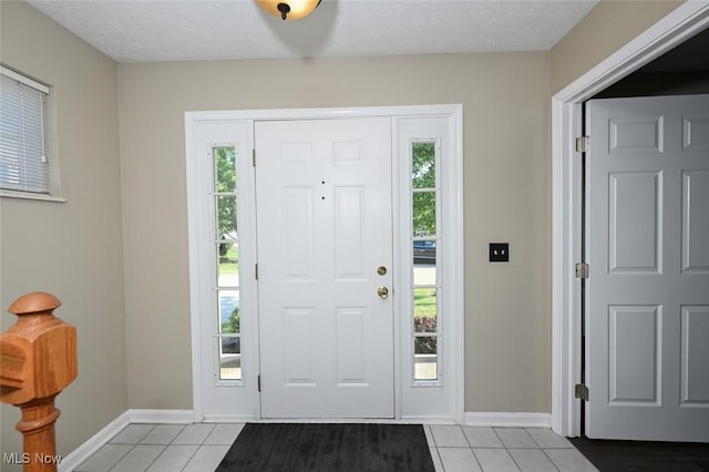 8714 Quailridge Ct, Macedonia, OH 44056 - foyer with light tile patterned floors, healthy amount of natural light, and a textured ceiling