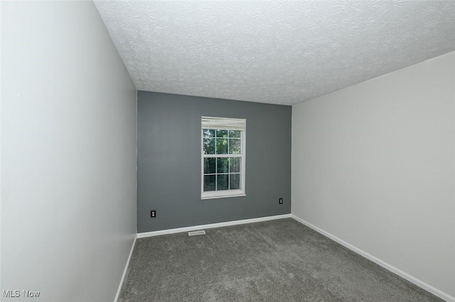 8714 Quailridge Ct, Macedonia, OH 44056 - spare room with a textured ceiling and dark carpet