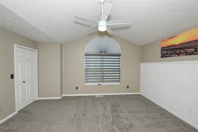 8714 Quailridge Ct, Macedonia, OH 44056 - empty room featuring lofted ceiling, ceiling fan, a textured ceiling, and carpet floors