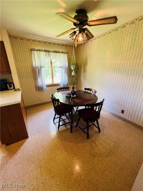 3174 Lynwood Dr NW, Warren, OH 44485 - dining space featuring wallpapered walls, ceiling fan, and light flooring