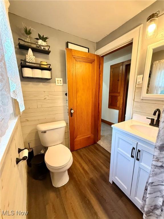 1257 Elmhurst Dr, Weirton, WV 26062 - bathroom featuring vanity, wood finished floors, and a wainscoted wall