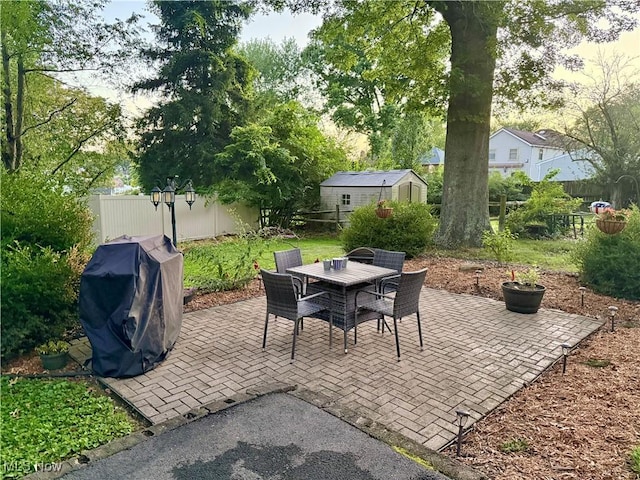 1257 Elmhurst Dr, Weirton, WV 26062 - fenced backyard with outdoor dining space, a patio area, grilling area, and a storage shed