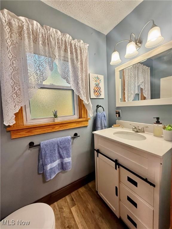 1257 Elmhurst Dr, Weirton, WV 26062 - half bath with a textured ceiling, wood finished floors, and vanity