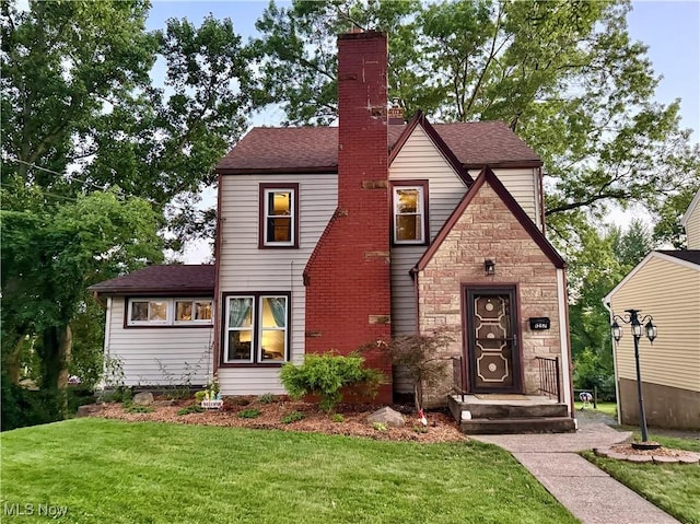 1257 Elmhurst Dr, Weirton, WV 26062 - english style home with a front lawn and roof with shingles