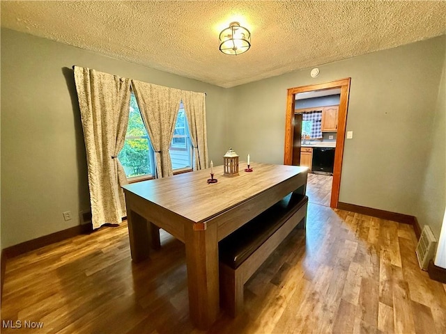 1257 Elmhurst Dr, Weirton, WV 26062 - dining area featuring a textured ceiling and wood finished floors