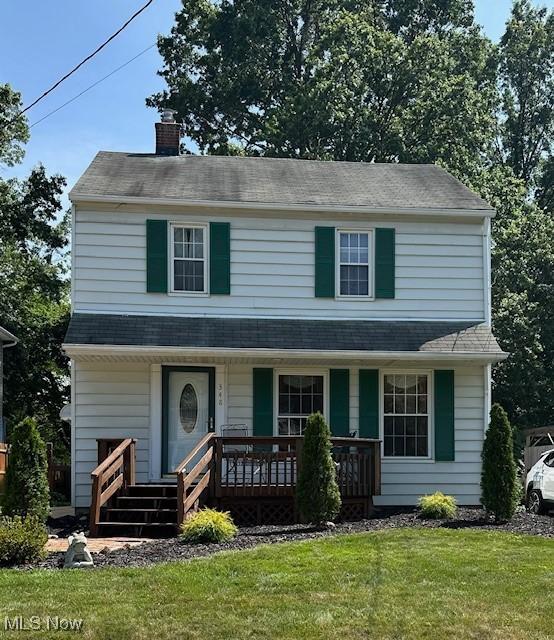 348 Birchwood Ave, Cuyahoga Falls, OH 44221 - view of front of house with a porch, a front lawn, a chimney, and a shingled roof