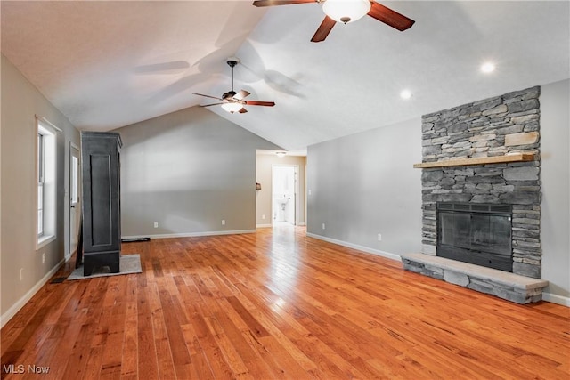 200 Breezy Acres Ln, Walker, WV 26180 - unfurnished living room with a ceiling fan, light wood-style flooring, vaulted ceiling, and a fireplace