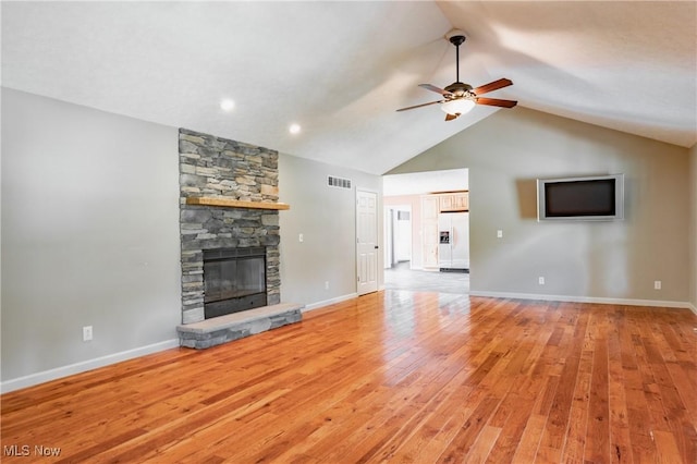 200 Breezy Acres Ln, Walker, WV 26180 - unfurnished living room with ceiling fan, a stone fireplace, light wood-style floors, and high vaulted ceiling
