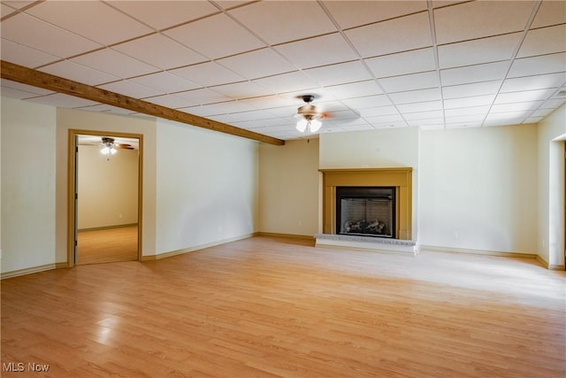 200 Breezy Acres Ln, Walker, WV 26180 - unfurnished living room with ceiling fan, light wood-style floors, a paneled ceiling, and a fireplace with raised hearth