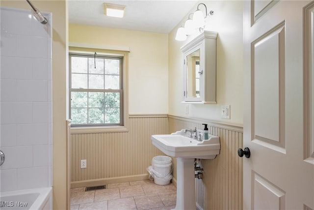 200 Breezy Acres Ln, Walker, WV 26180 - bathroom with a wainscoted wall, tile patterned flooring, and bathtub / shower combination