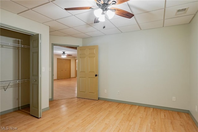 200 Breezy Acres Ln, Walker, WV 26180 - unfurnished bedroom with light wood-style flooring, a closet, a paneled ceiling, and ceiling fan