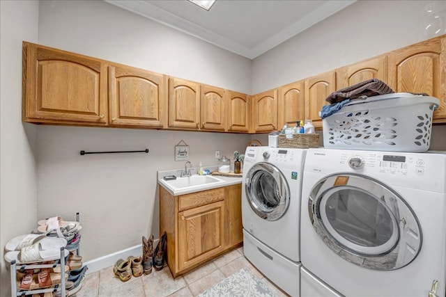 laundry area featuring crown molding, sink, independent washer and dryer, light tile patterned floors, and cabinets