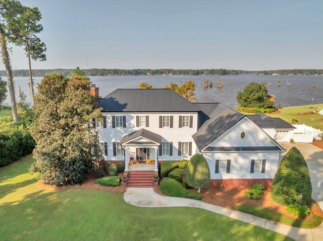 colonial inspired home featuring a water view and a front yard