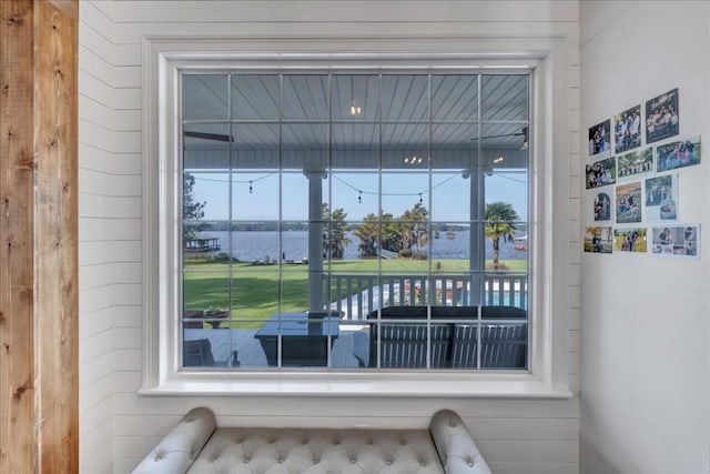 room details featuring wood walls and a water view