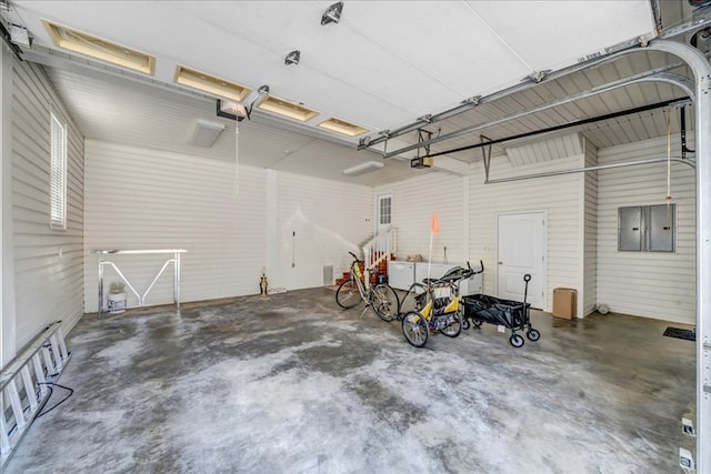 garage featuring electric panel and a garage door opener