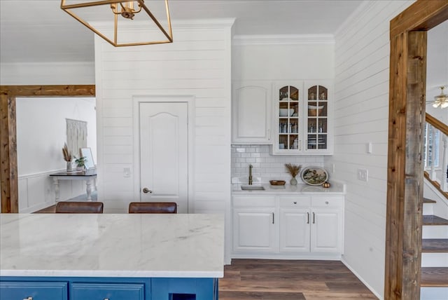 kitchen featuring white cabinetry, blue cabinetry, and dark hardwood / wood-style flooring