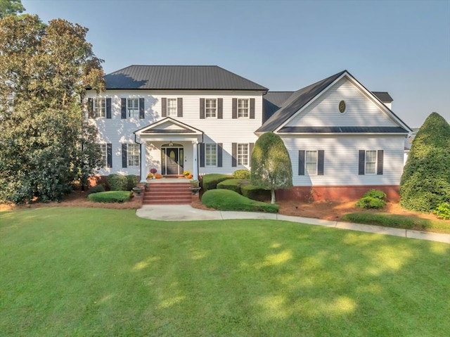 colonial-style house with a front lawn