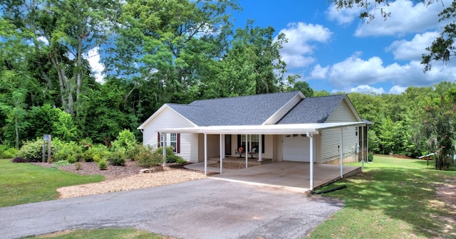 single story home featuring a front yard, a carport, and a garage