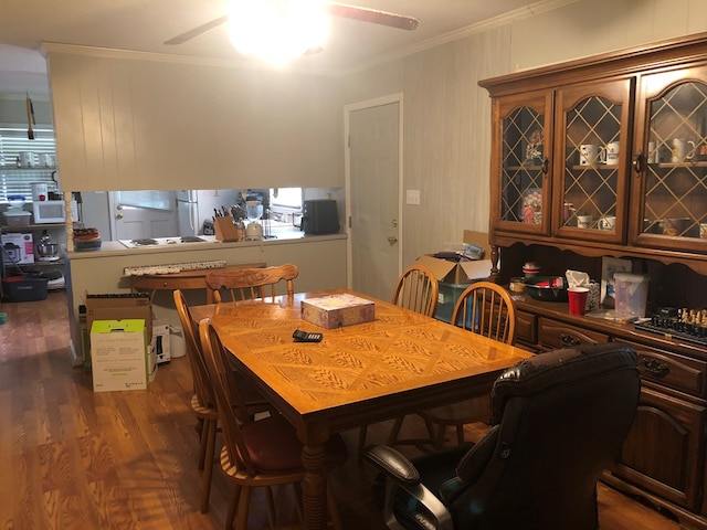 2814 Reeves Ln, Albany, GA 31721 - dining space with crown molding, ceiling fan, and dark wood-type flooring