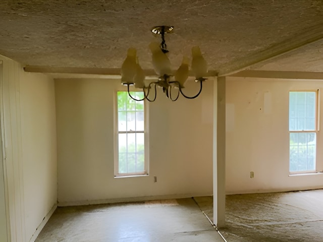 unfurnished dining area featuring an inviting chandelier