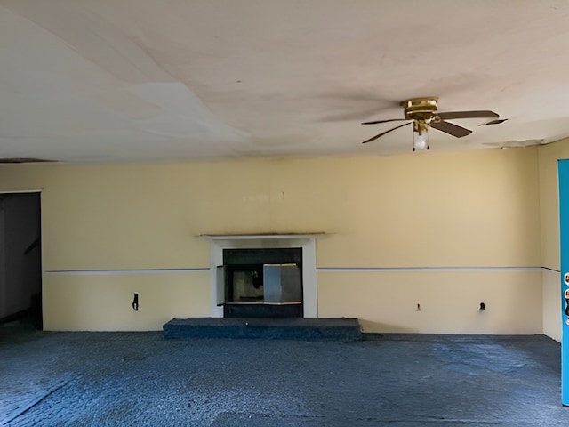 unfurnished living room with ceiling fan