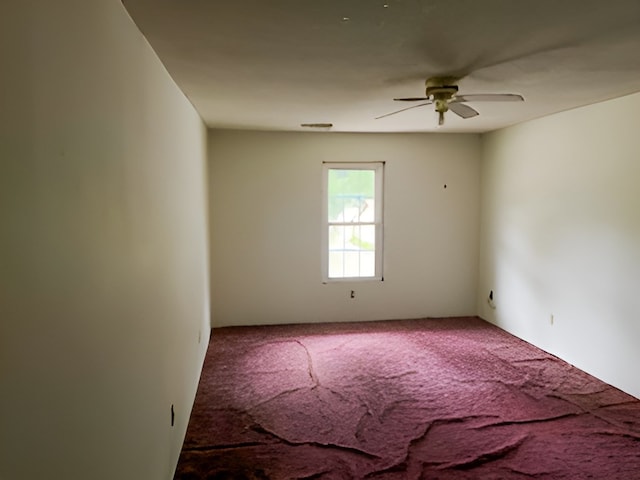 empty room featuring carpet flooring and ceiling fan