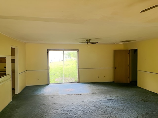 spare room featuring ceiling fan and carpet flooring