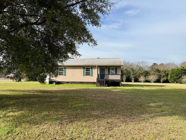 view of front of home with crawl space, a front lawn, and metal roof