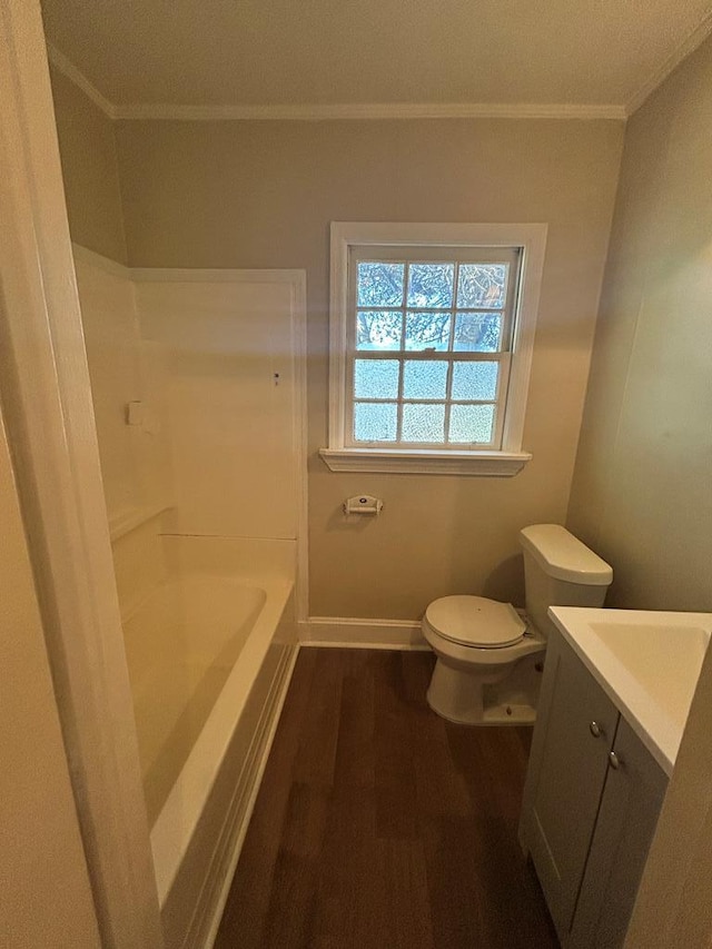 bathroom featuring hardwood / wood-style flooring, toilet, vanity, and crown molding