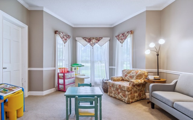 sitting room featuring ornamental molding and carpet flooring