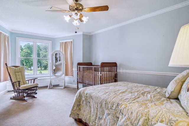 carpeted bedroom with a textured ceiling, ceiling fan, and ornamental molding