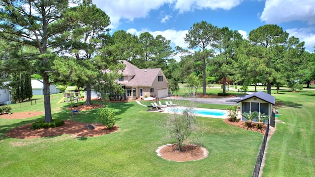 view of pool with a yard