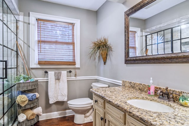 bathroom with hardwood / wood-style floors, toilet, and vanity