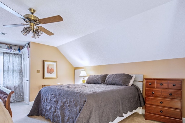 carpeted bedroom featuring ceiling fan, a textured ceiling, and vaulted ceiling